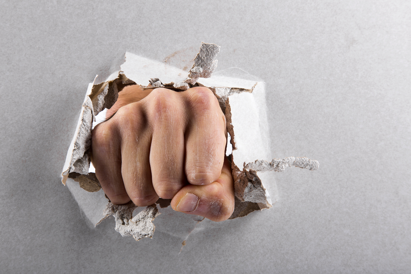 Aggression Concept, Wall Is Broken Through By A Fist